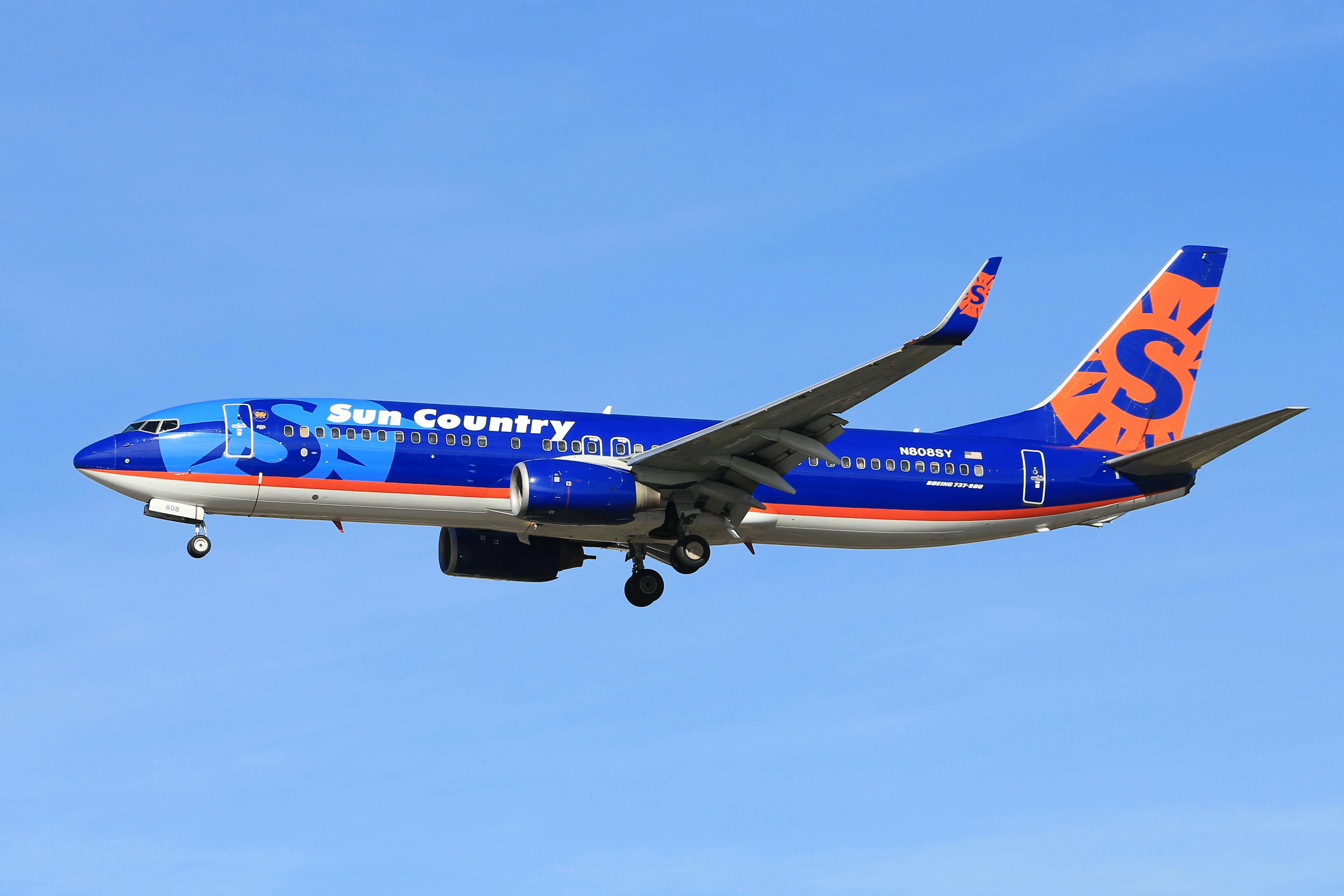 Boeing-737-from-Sun-Country-Airlines-soaring-against-a-clear-blue-sky. Boeing 737 from Sun Country Airlines soaring against a clear blue sky.