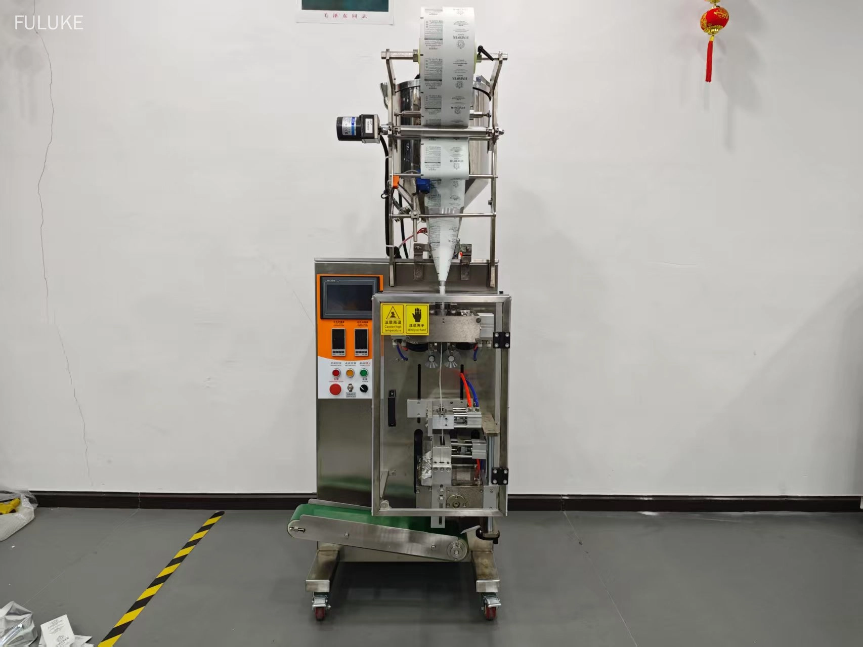 Stainless steel automatic liquid bag packaging machine with touchscreen control panel. - FULUKE