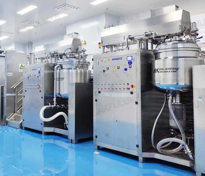 Industrial stainless steel mixing tanks in a clean room with blue floor. - FULUKE