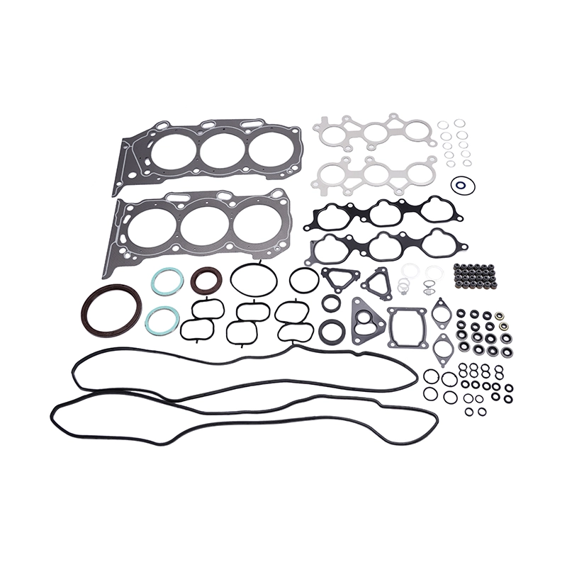 A comprehensive engine gasket set laid out on a white background, featuring head gaskets, intake and exhaust manifold gaskets, valve cover gaskets, and numerous O-rings and seals of varying sizes and materials.