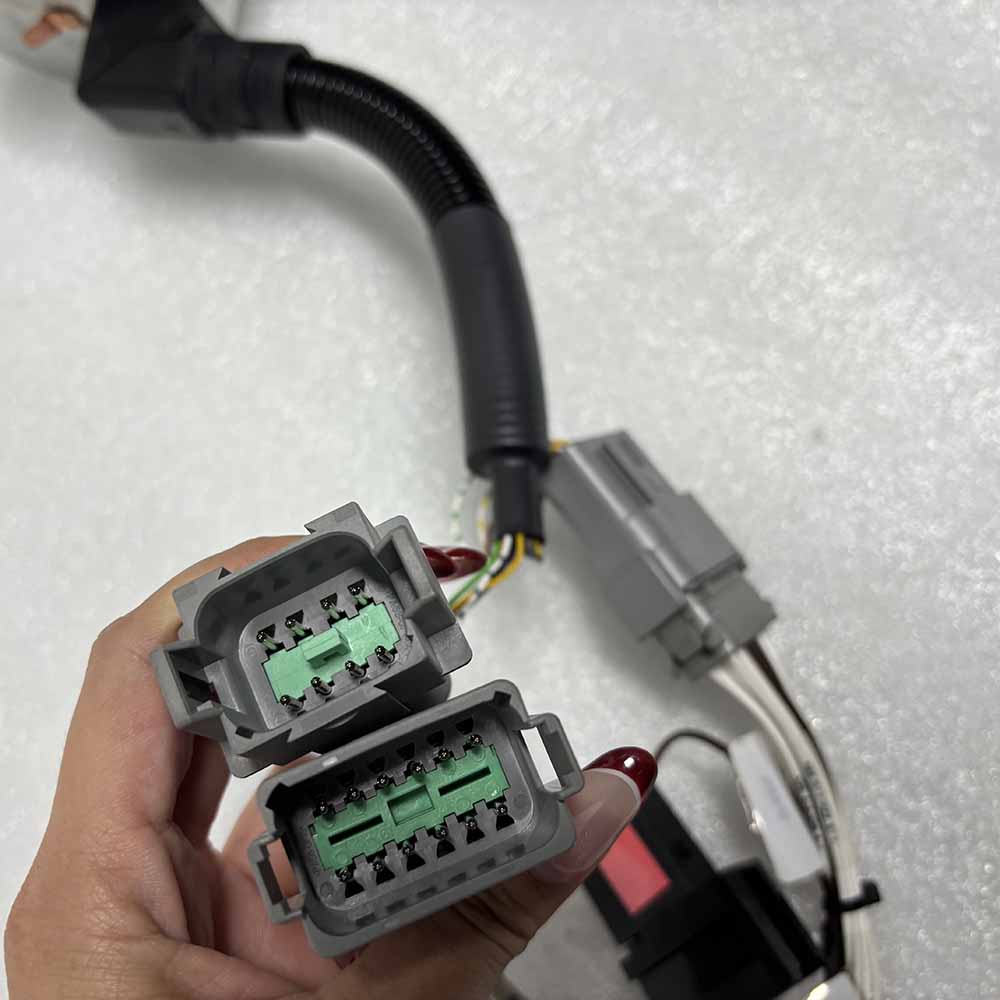 05754873 Close-up of two grey multi-pin electrical connectors for a vehicle wire harness.