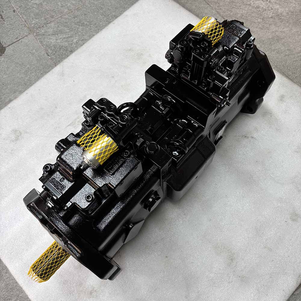 Black industrial hydraulic piston pump for heavy machinery on a stone surface.