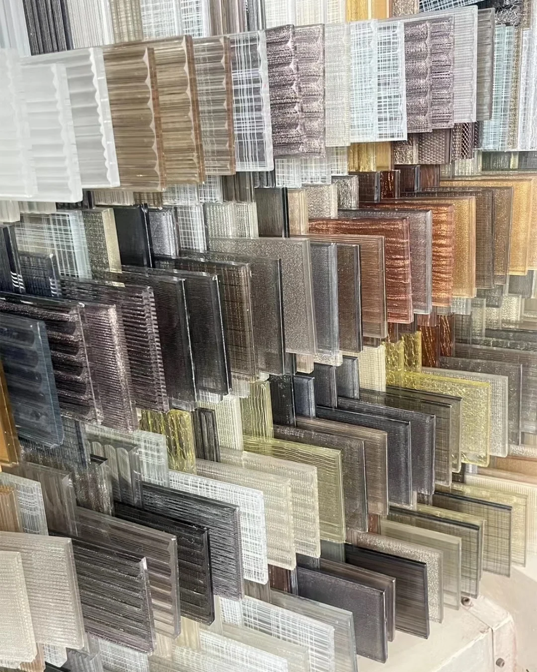 dense-display-of-textured-art-glass-panels-with-embossed-patterns-for-luxury-hotel-spaces