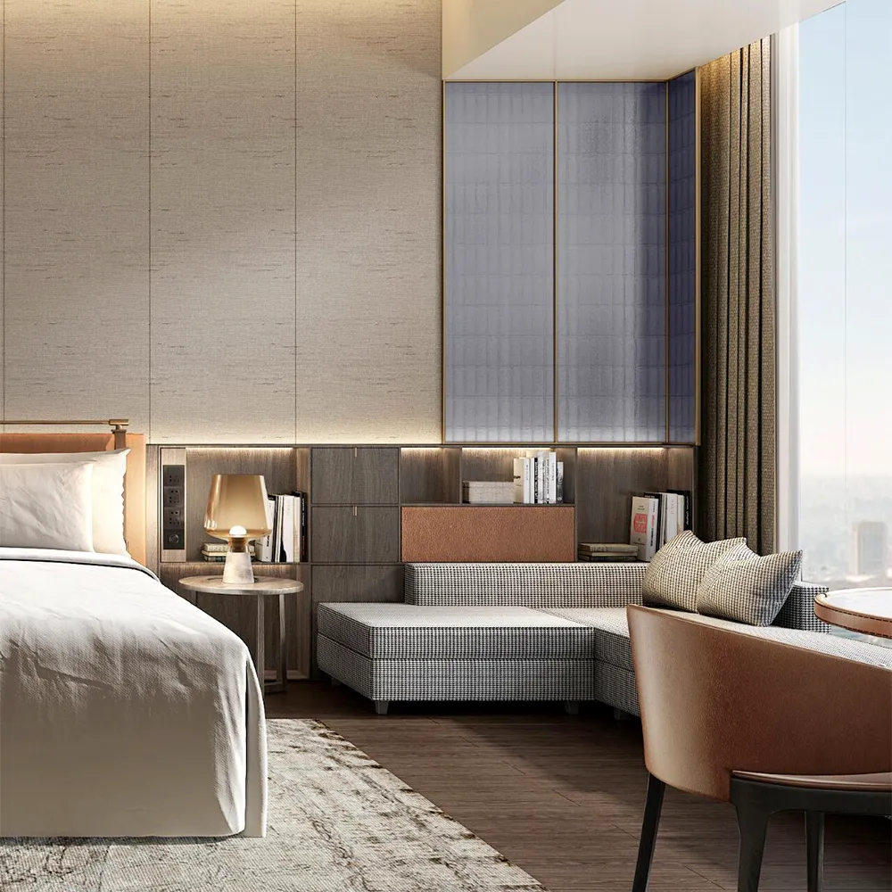 Modern hotel suite featuring a king bed, ambient-lit headboard, modular seating by window, and textured wall panels.