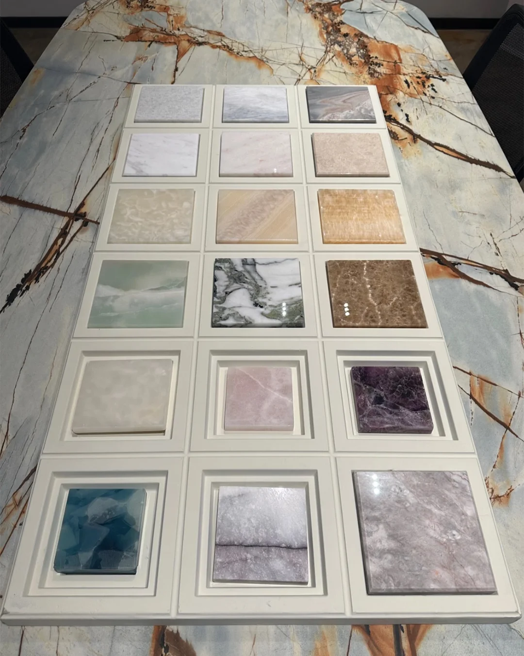 square-stone-sample-tray-on-marble-table-for-hotel-finish-selection-and-interior-design