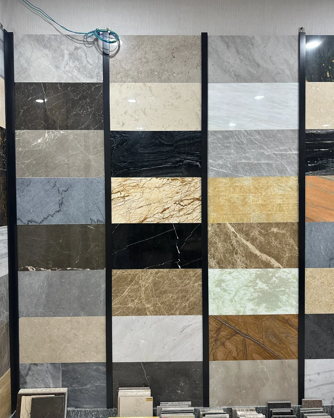 striped-marble-and-quartz-slab-display-wall-in-black-frame-for-hotel-floors-and-countertops