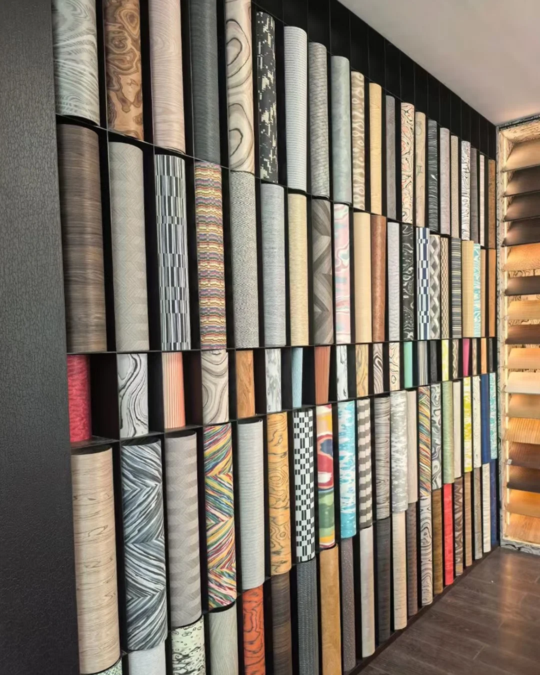 wall-of-rolled-decorative-surfaces-in-wood-marble-and-abstract-patterns-for-hotel-projects