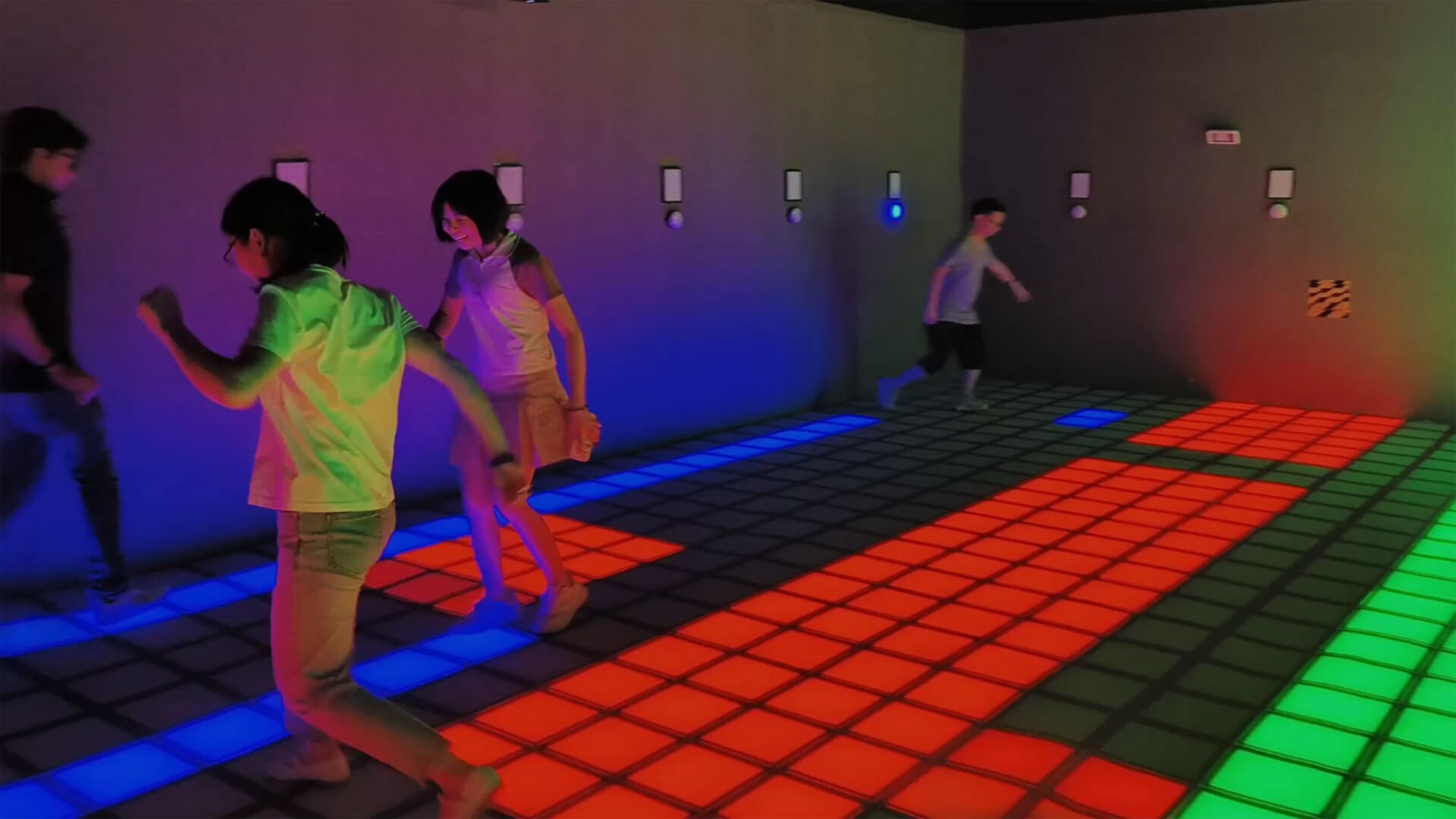 LED grid floor game system with colorful light-up tiles for active entertainment venues