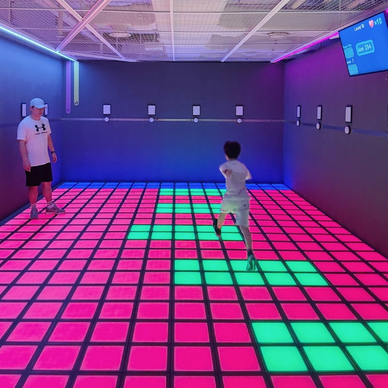 Interactive LED floor tiles game with pixel grid and floor is lava challenge