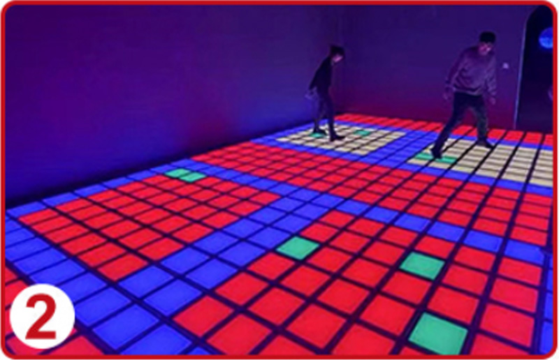 Interactive LED floor grid game where players step on safe tiles and avoid red danger tiles