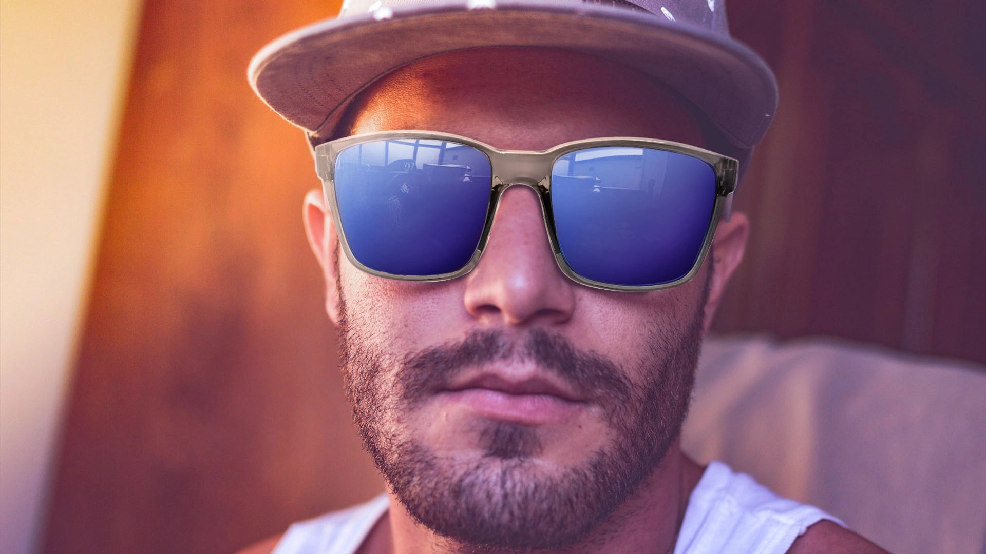 Sunglasses protect a man's eyes from the sun.