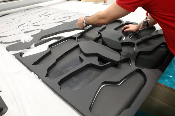 Cut foam rubber shapes on a cutting mat.