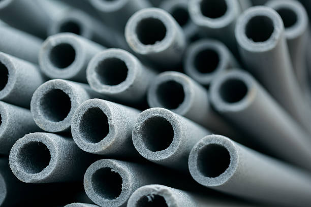 rubber pipe insulation vs foam Here's an alt text option for the image:Rubber pipe insulation vs foam: close-up of gray pipe insulation.