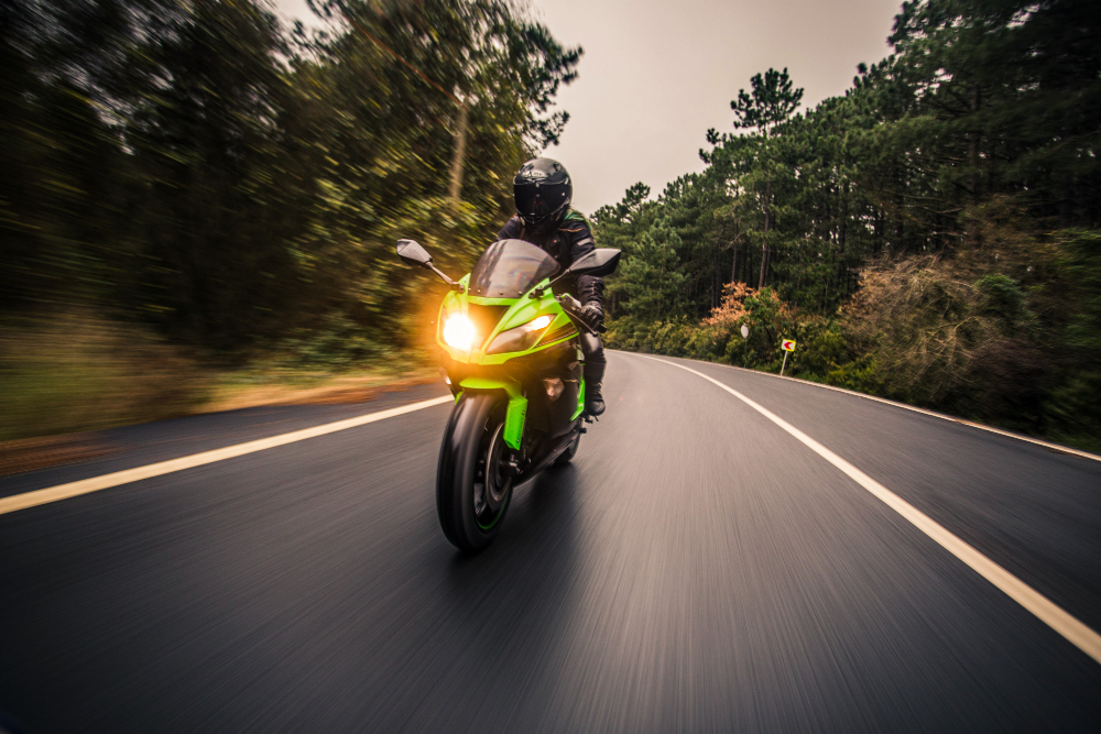 motorcycle led light pods Fast motorcycle with bright motorcycle LED light pods on a scenic road.