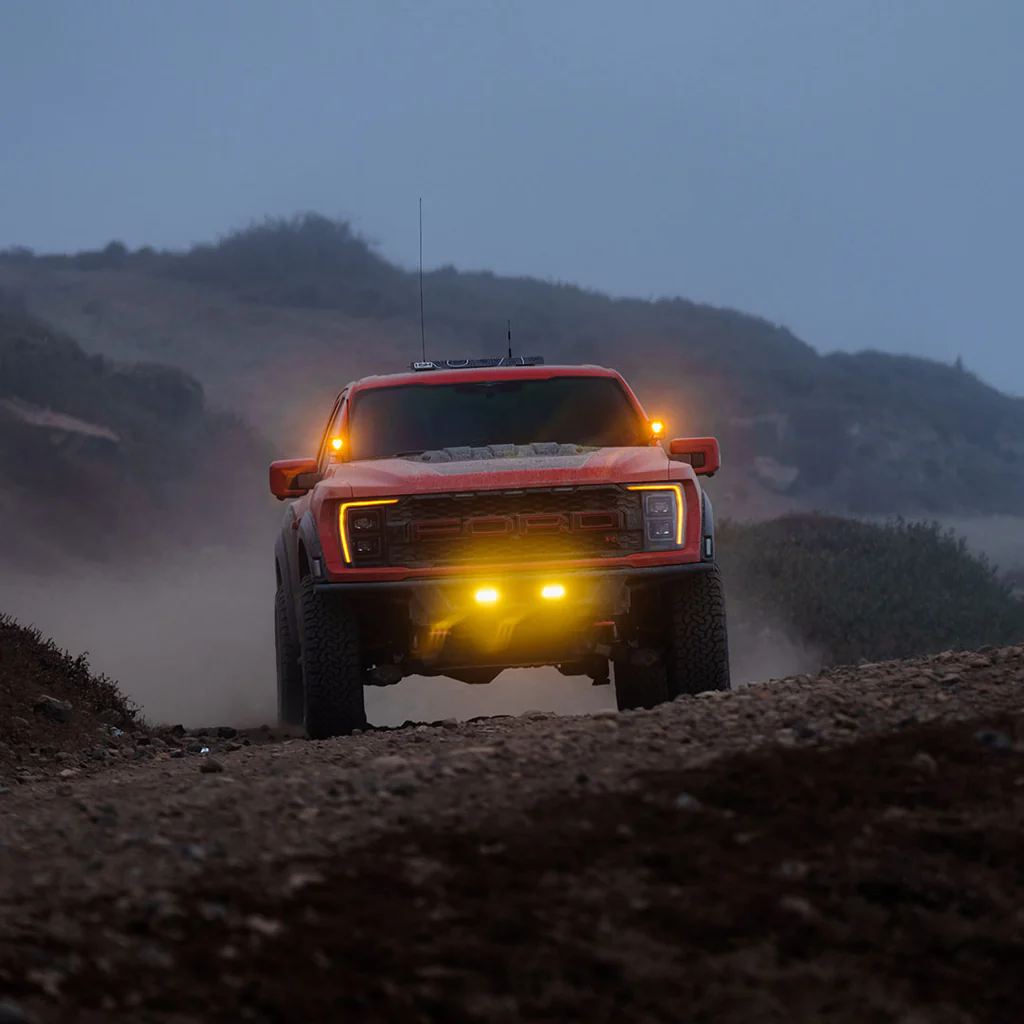 Red Ford Raptor with bright off road pod light. Red Ford Raptor with bright off road pod light.
