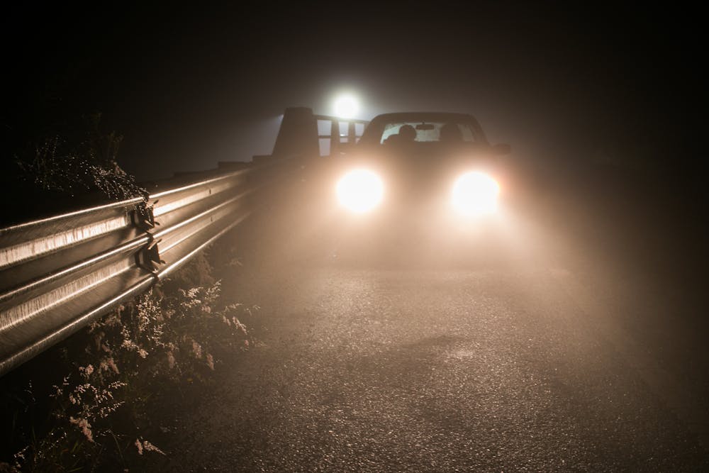 Car driving in fog with automotive LED fog lights​.