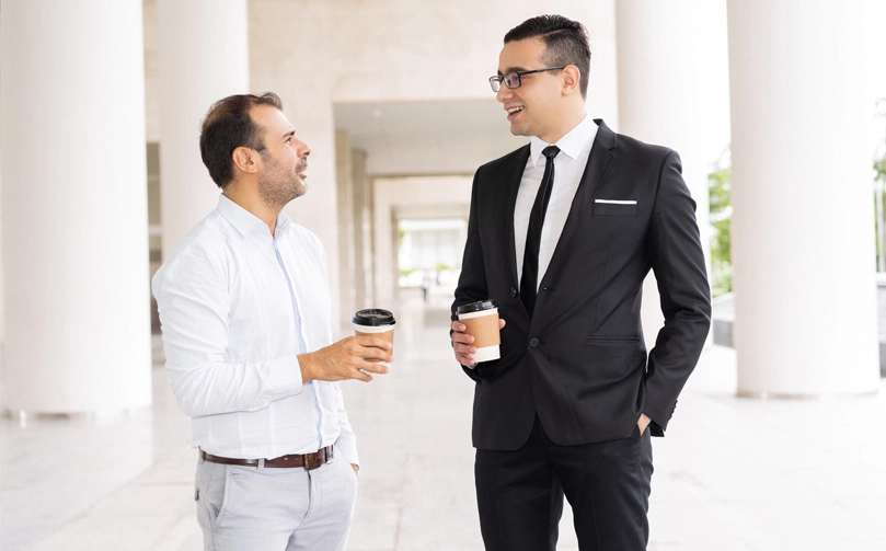 portrait-male-business-colleagues-drinking-coffee-talking_1262-15055