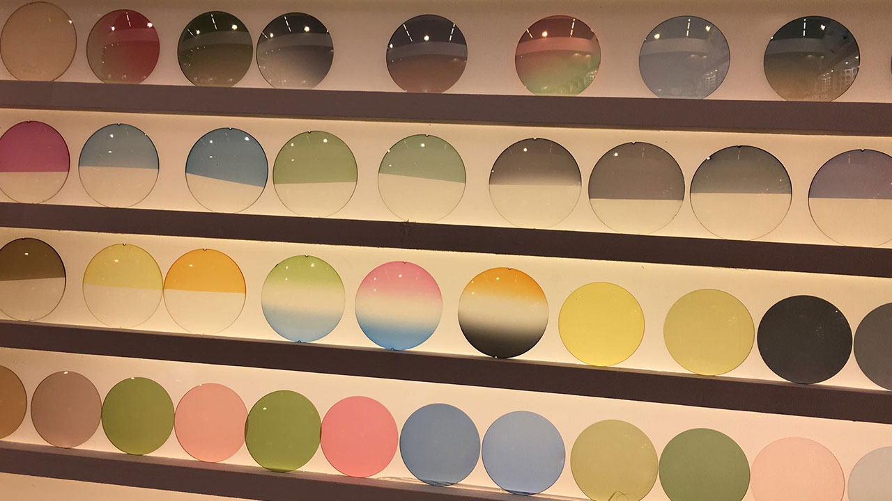 glasses lenses Eyeglass lens tint samples displayed on a rack.
