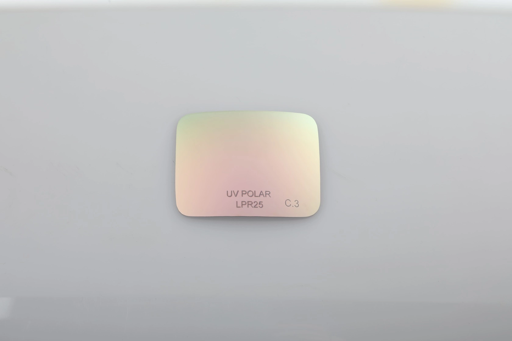 Close-up of a UV Polar LPR25 C.3 sunglass lens. - KARUSON