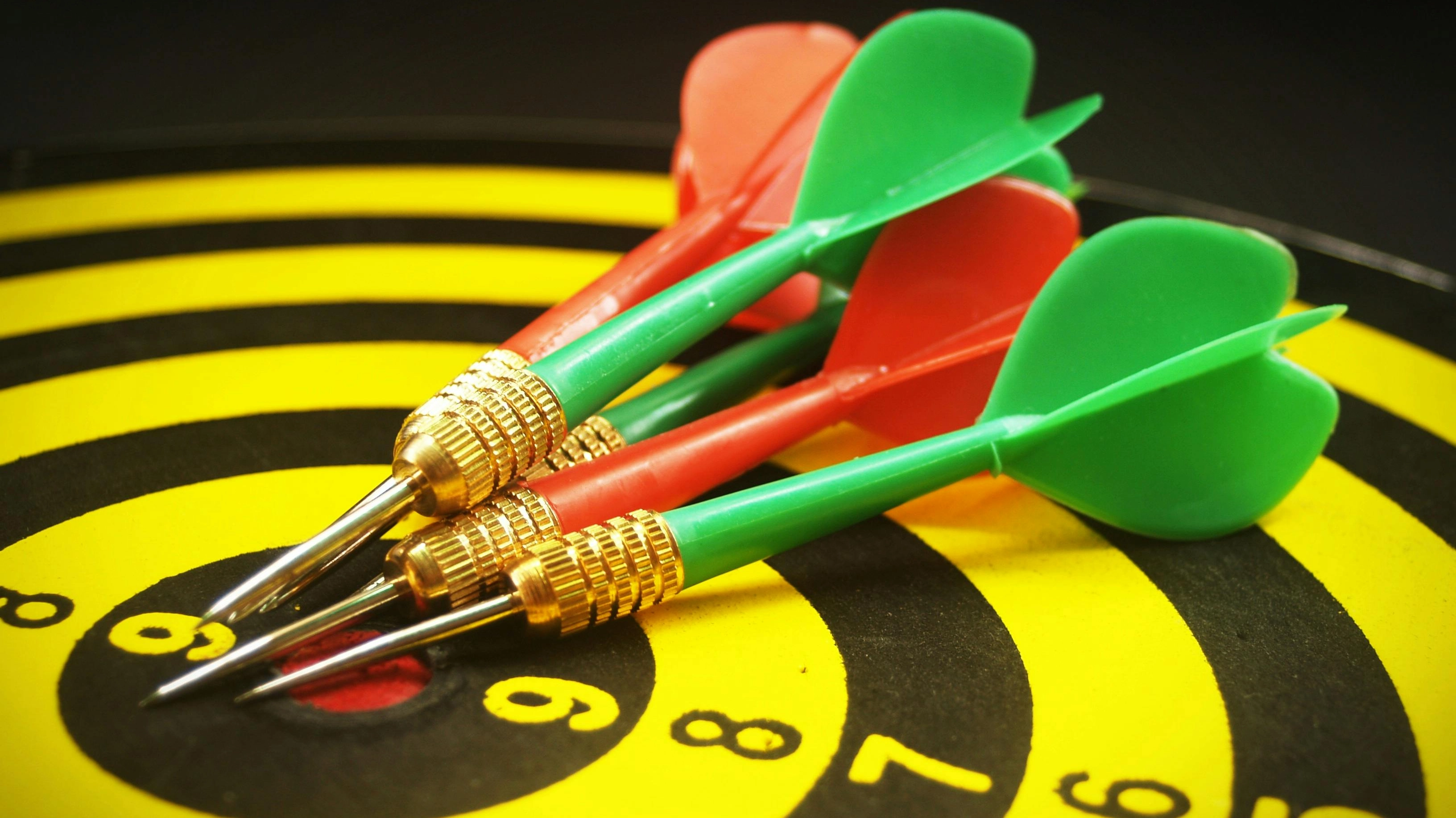 Vibrant-image-of-precision-darts-hitting-the-bullseye-on-a-colorful-dartboard_ Vibrant image of precision darts hitting the bullseye on a colorful dartboard_