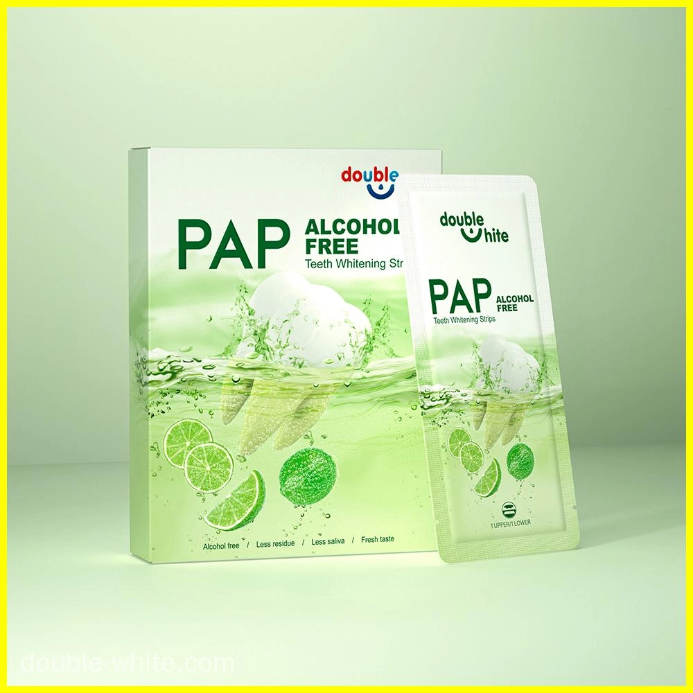 علبة من شرائط تبييض الأسنان الخالية من الكحول Double White PAP+. العلبة باللونين الأخضر والأبيض، والشرائط في عبوة مغلقة.