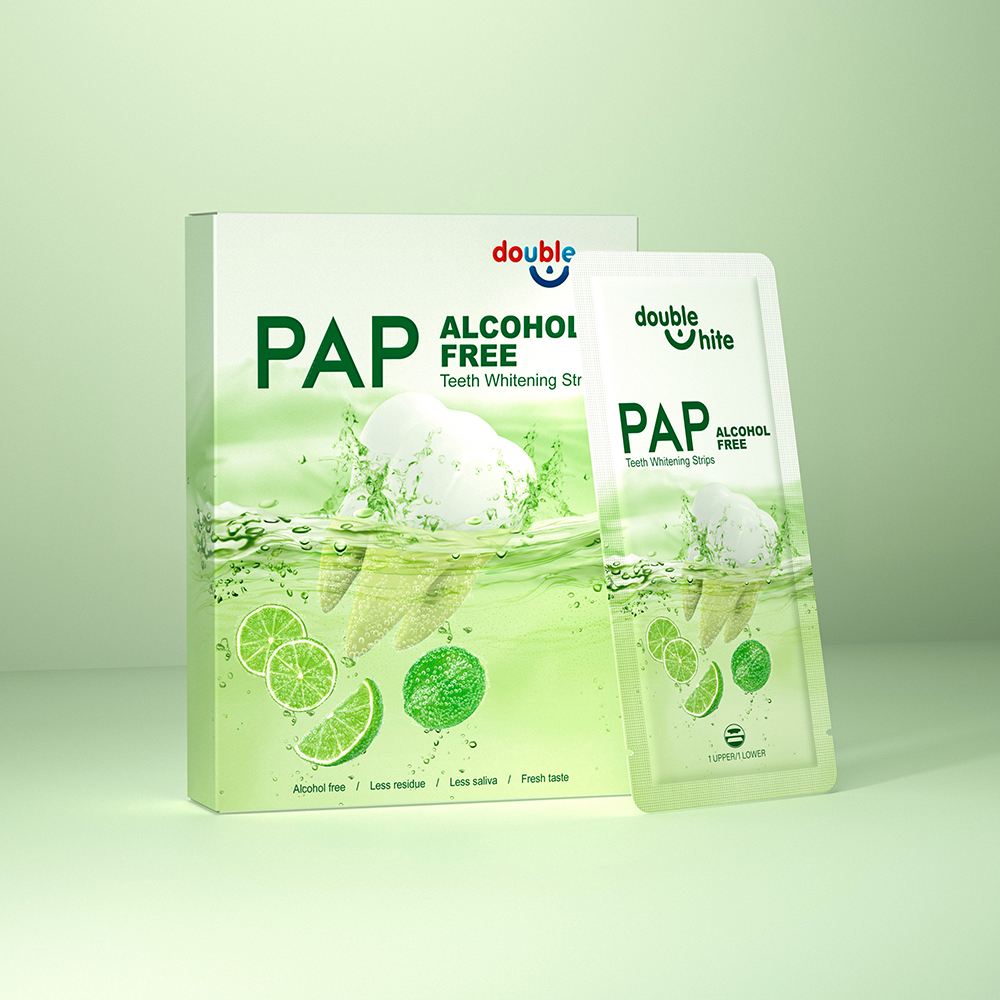 A box of Double White PAP+ Alcohol Free Teeth Whitening Strips. The box is green and white, and the strips are in a sealed packet.