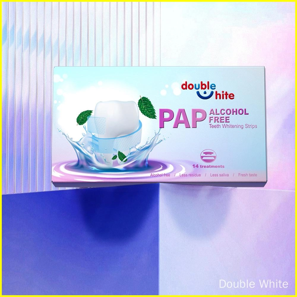 A box of Double White PAP+ Alcohol-Free Teeth Whitening Strips. The box is white and purple, and the front of the box has a picture of a tooth with a green leaf next to it.