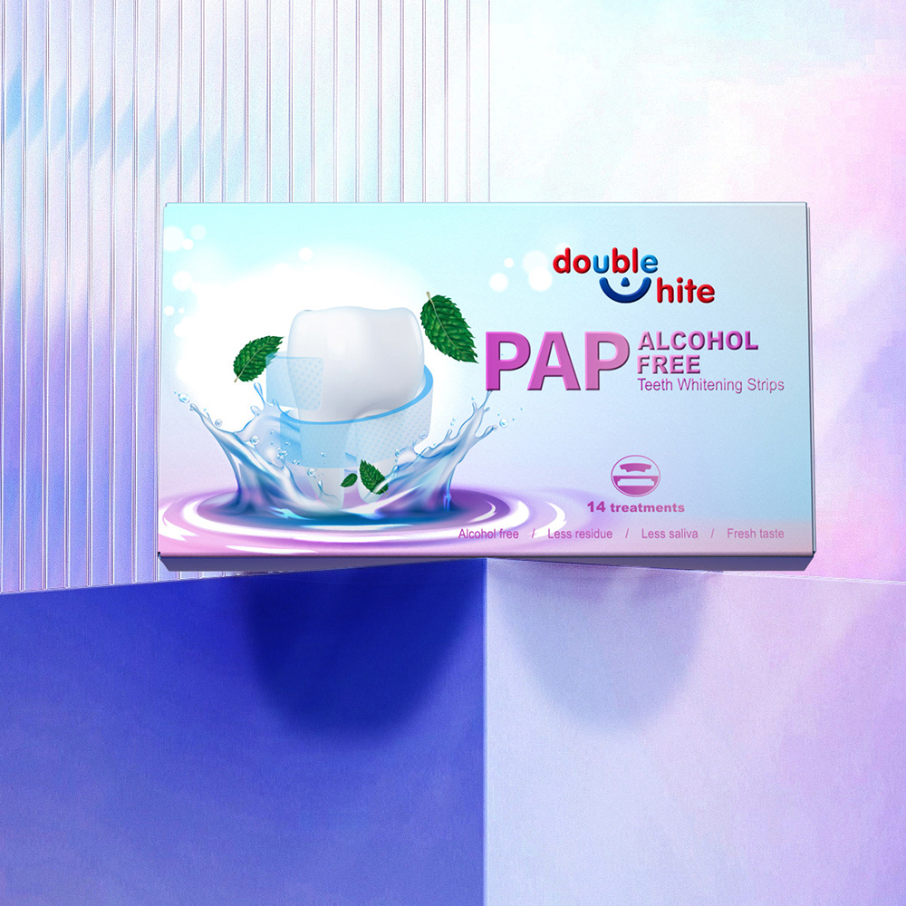 A box of Double White PAP+ Alcohol-Free Teeth Whitening Strips. The box is white and purple, and the front of the box has a picture of a tooth with a green leaf next to it.