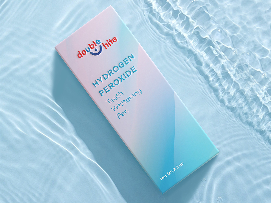 A box of Double White Hydrogen Peroxide Teeth Whitening Pen. The box is white and blue and is sitting on a blue watery surface.