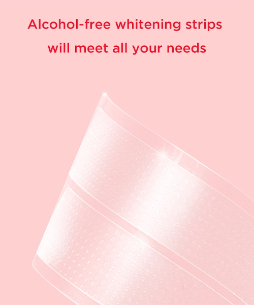 A close-up image of two alcohol-free whitening strips against a pink background.