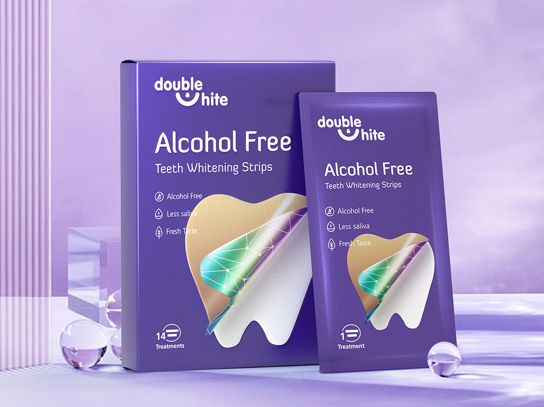 A box of Double White Alcohol Free Teeth Whitening Strips. The box is purple and white, with a picture of a smiling mouth on the front. The strips are in a sealed packet inside the box.