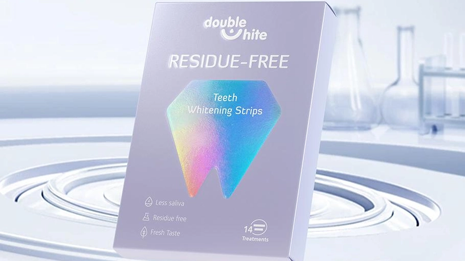 A box of Double White Residue Free Teeth Whitening Strips. The box is white and purple with a diamond-shaped window on the front.