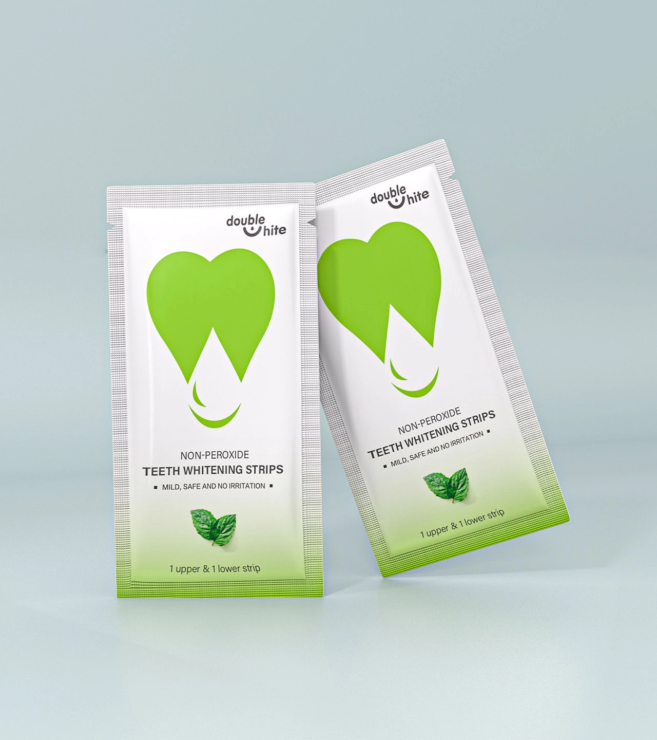 Two green and white packages of Double White non-peroxide teeth whitening strips.