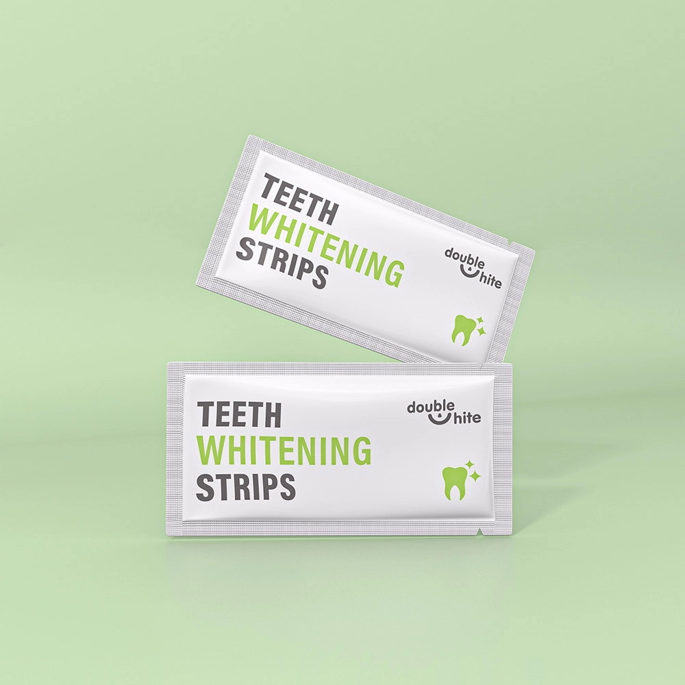 Two white and green packages of Double White teeth whitening strips.