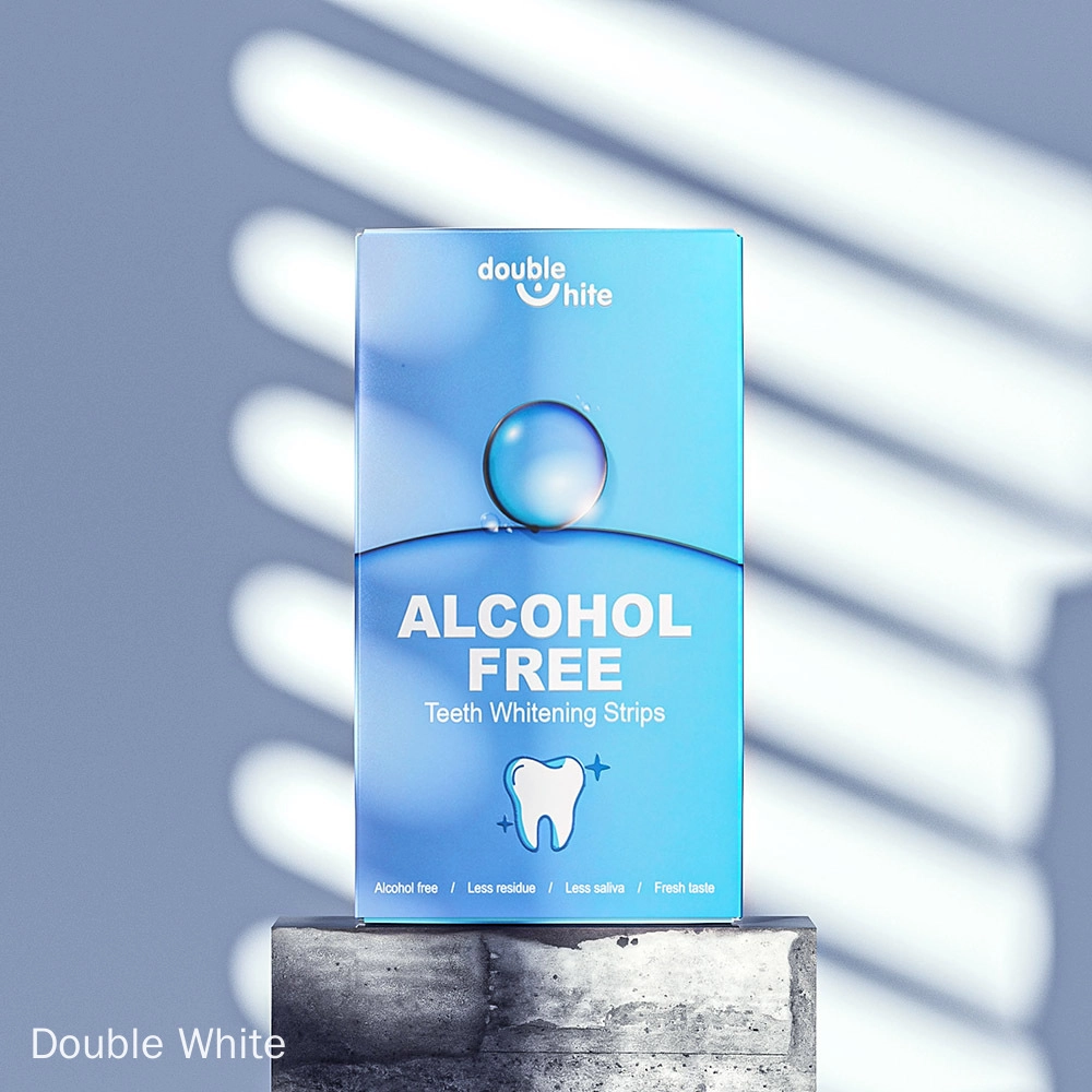 Une boîte de bandes blanchissantes pour les dents Double White. La boîte est bleue et blanche, avec le logo Double White et le texte « Sans alcool » sur le devant.