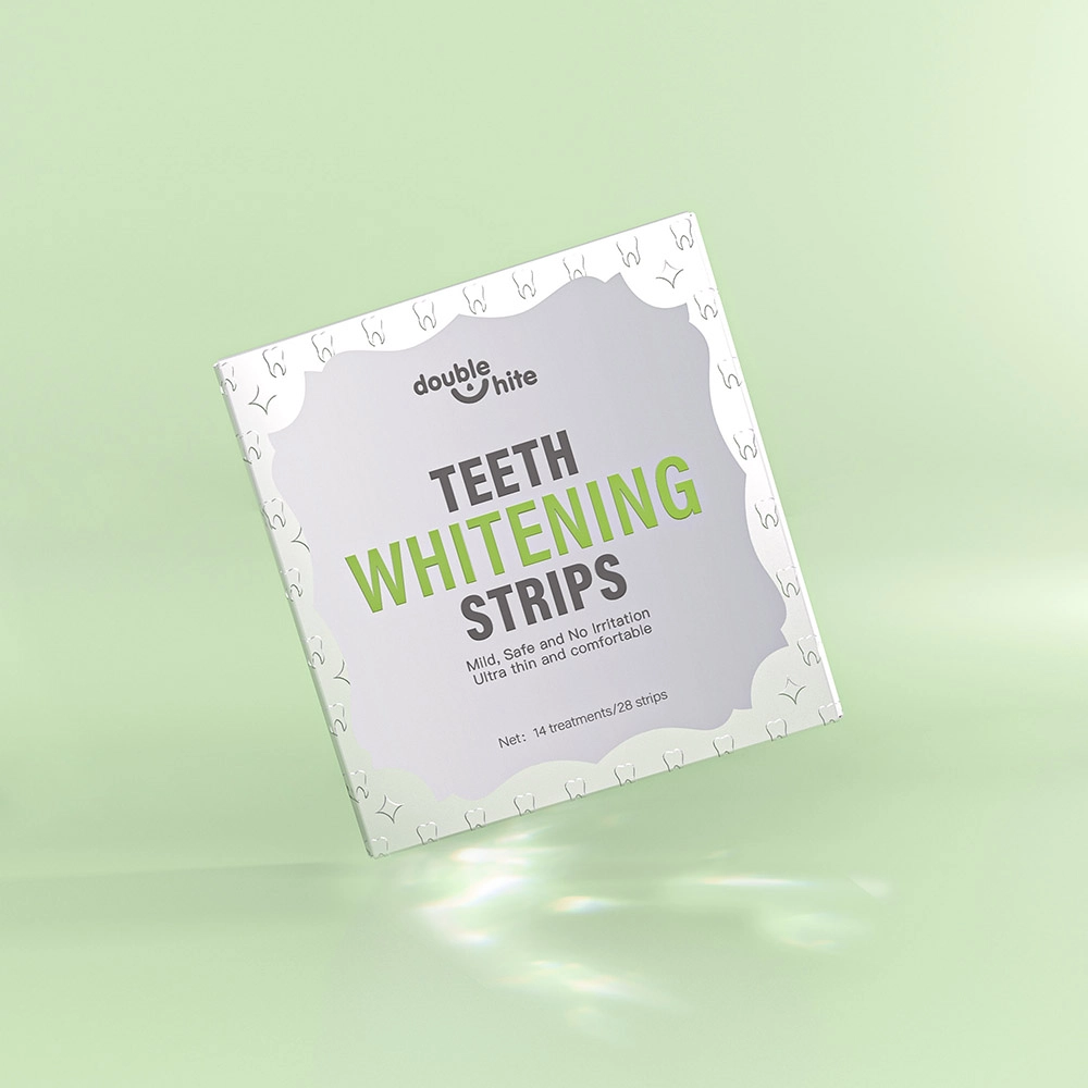 A box of Double White teeth whitening strips. The box is white with green text and a green leaf design. The box is sitting on a solid green background.