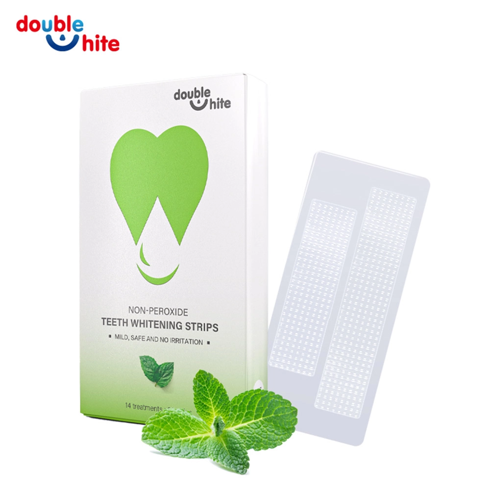 Two green and white packages of Double White non-peroxide teeth whitening strips.