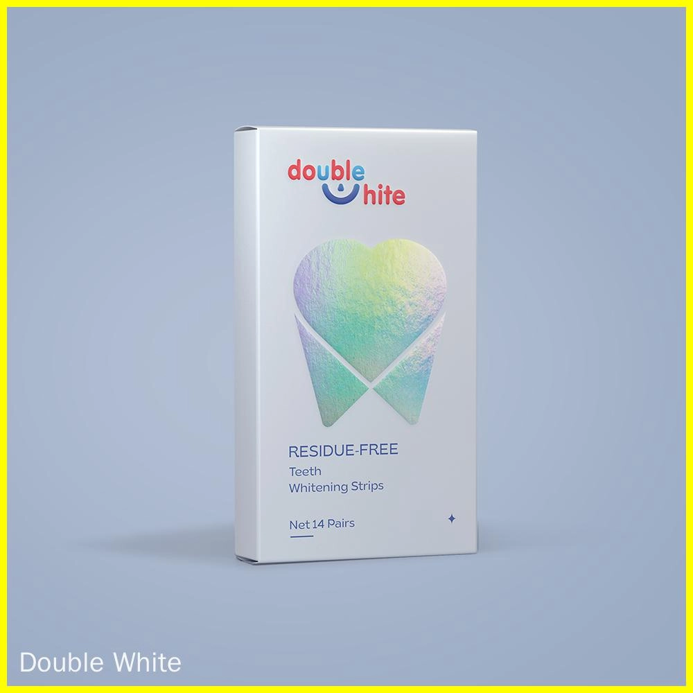 A box of Double White teeth whitening strips. The box is white with a blue and pink gradient tooth on the front. The text on the box is "double white", "residue-free", "teeth whitening strips", and "net 14 pairs".