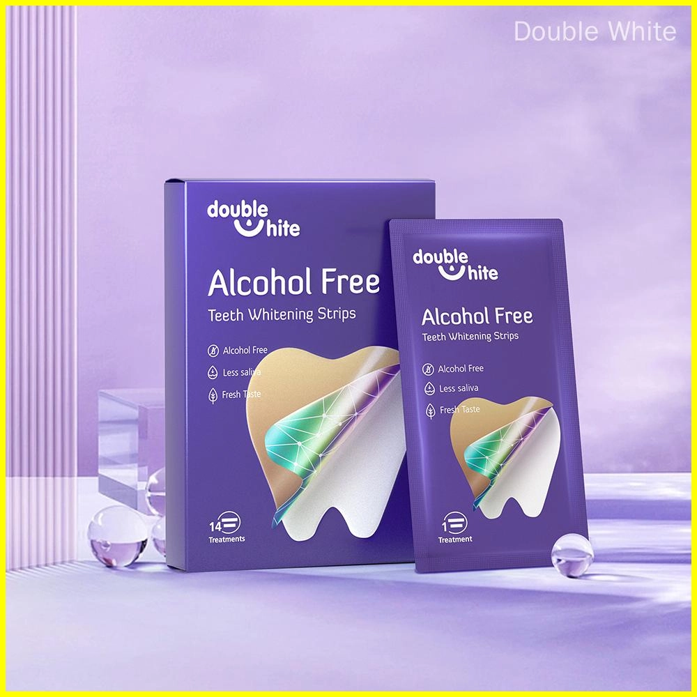 A box and a packet of Double White Alcohol Free Teeth Whitening Strips. The box is purple and white, and the packet is purple. The box has 14 treatments, and each packet has one treatment.