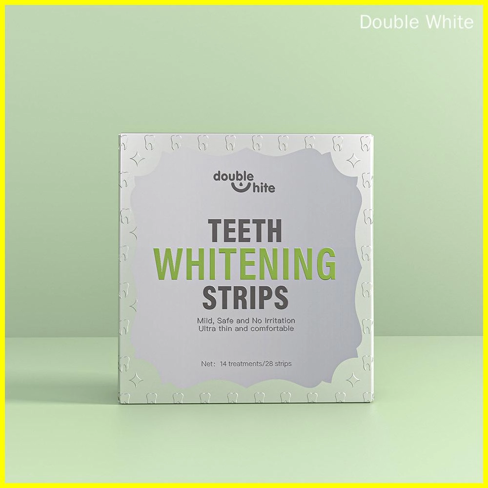 A box of Double White teeth whitening strips. The box is white with green text and a green leaf design. The front of the box displays the product name, logo, and a list of the product's benefits.