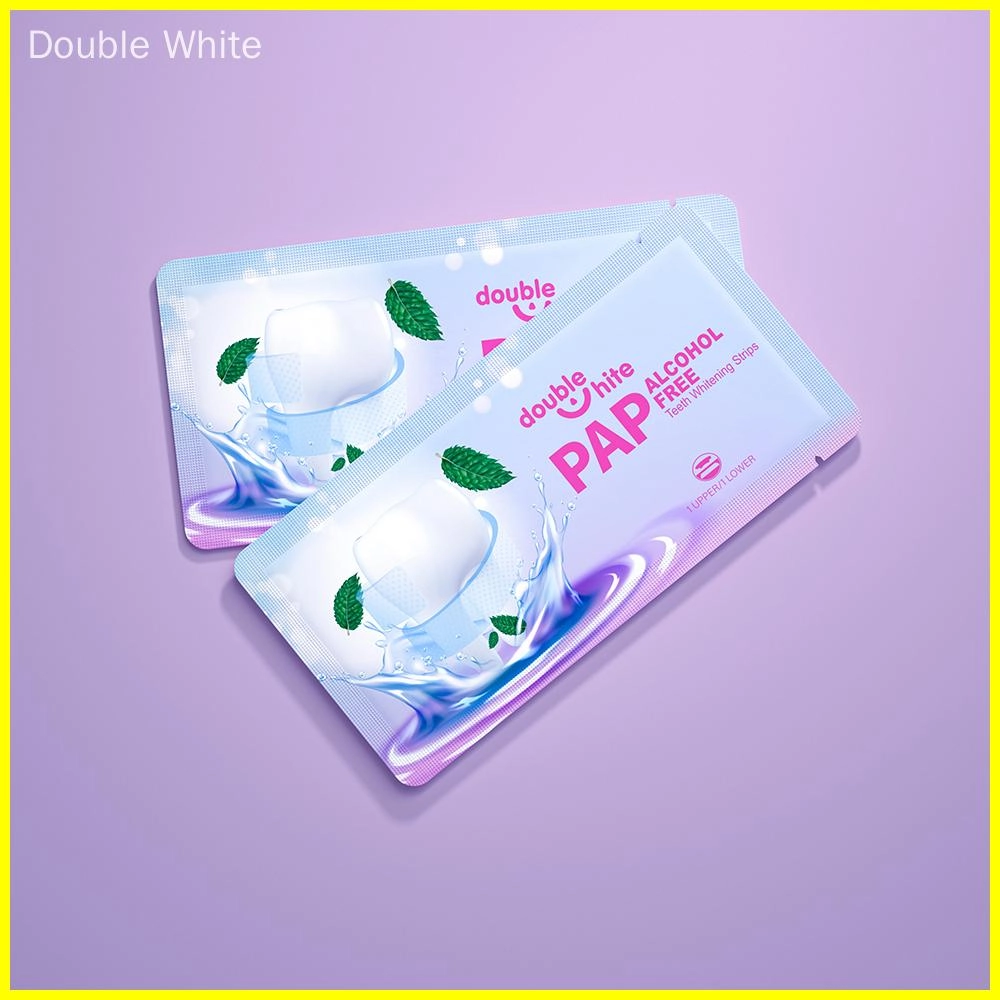 A product image of Double White PAP Free Alcohol Free Teeth Whitening Strips. The packaging is white and purple with a picture of a smiling mouth with two green mint leaves.