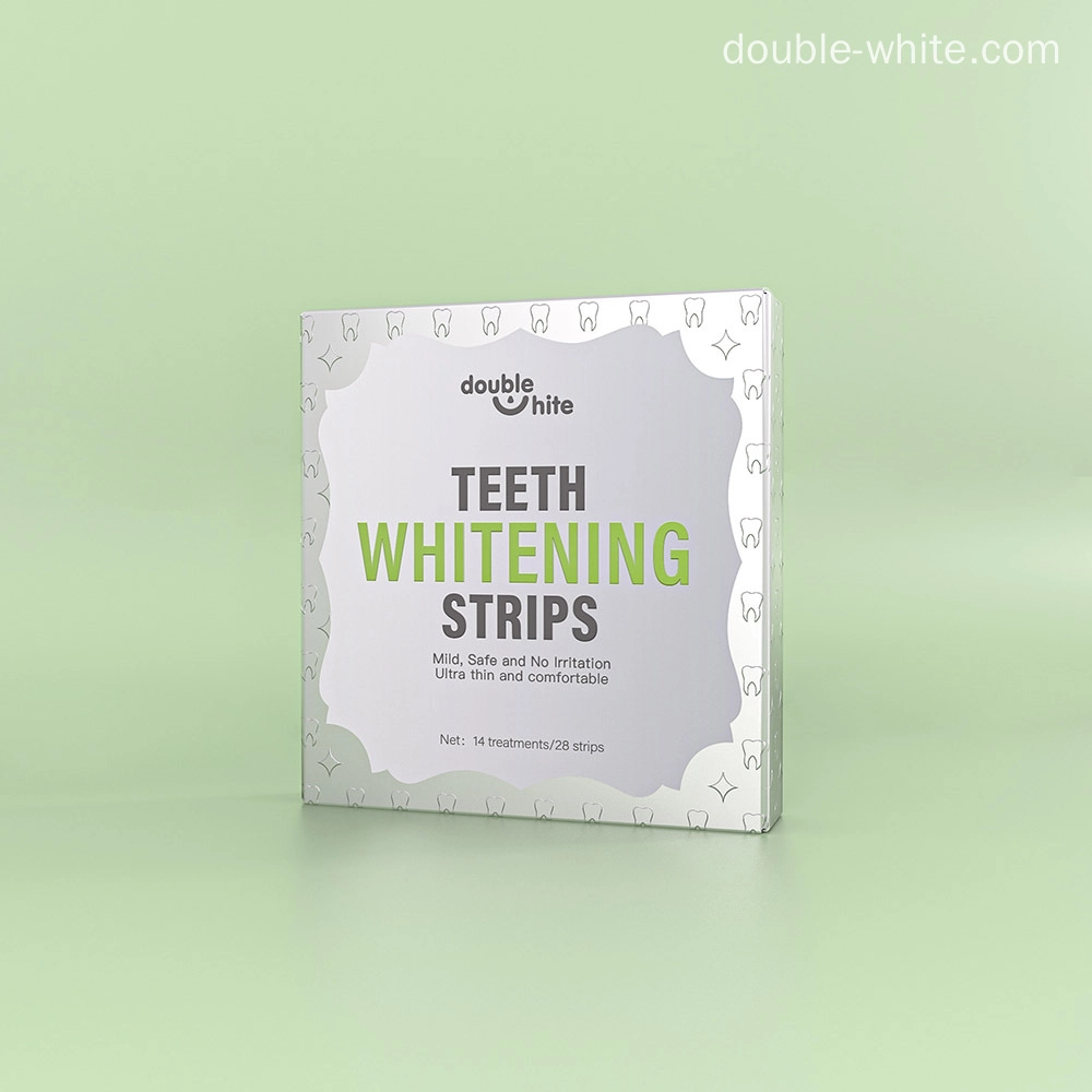 A box of Double White Teeth Whitening Strips. The box is white and green. The front of the box has the Double White logo, the product name, and a list of the product's benefits.