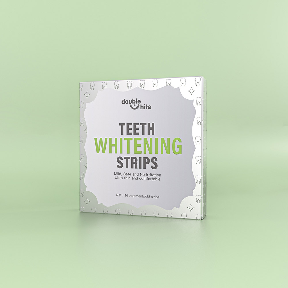 A box of Double White Teeth Whitening Strips. The box is white and green. The front of the box has the Double White logo, the product name, and a list of the product's benefits.