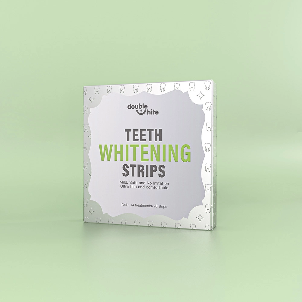 A box of Double White Teeth Whitening Strips. The box is white and green. The front of the box has the Double White logo, the product name, and a list of the product's benefits.