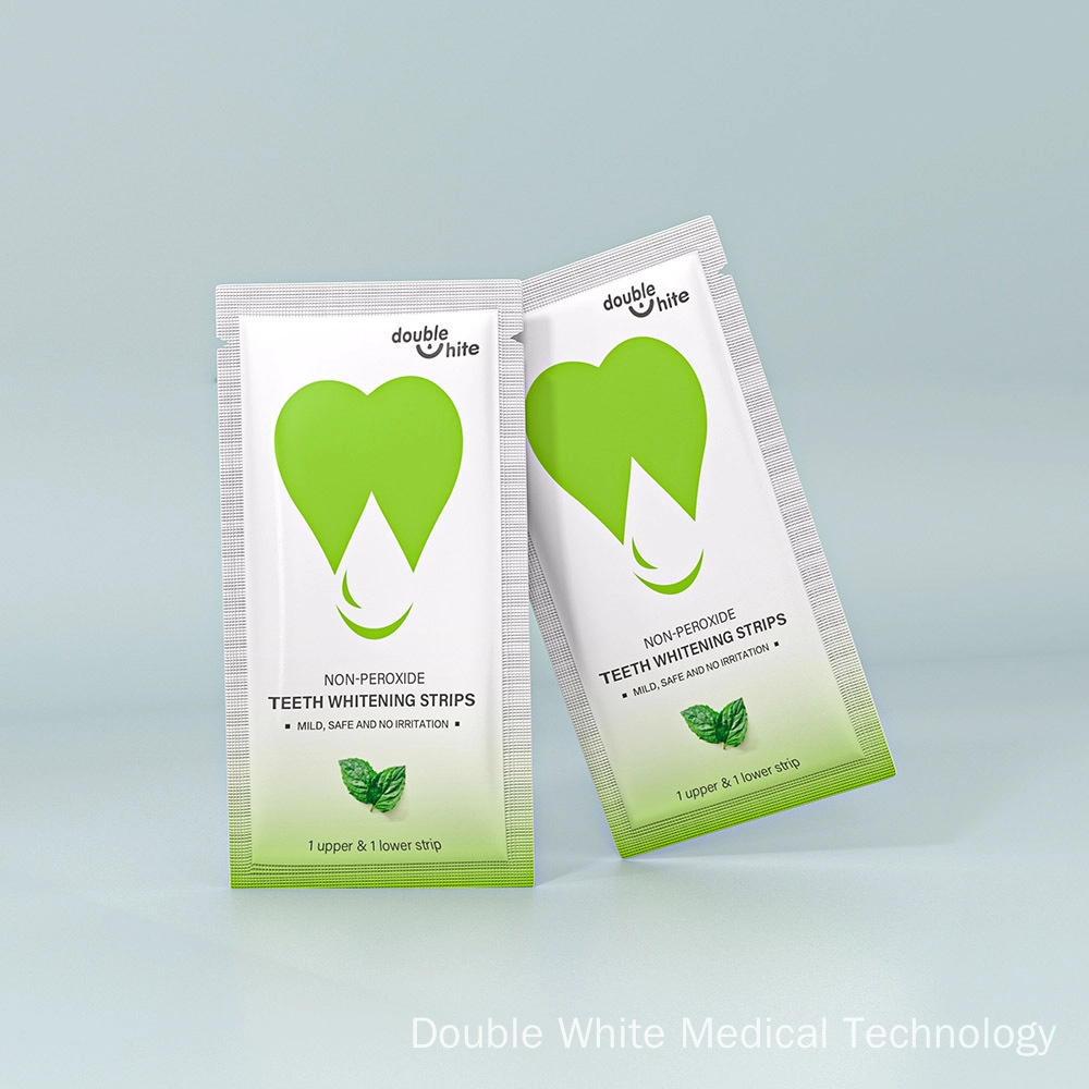 Two green and white packages of Double White non-peroxide teeth whitening strips.