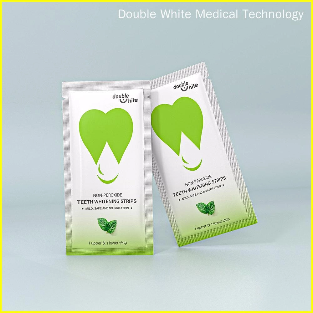 Two green and white packages of Double White non-peroxide teeth whitening strips.