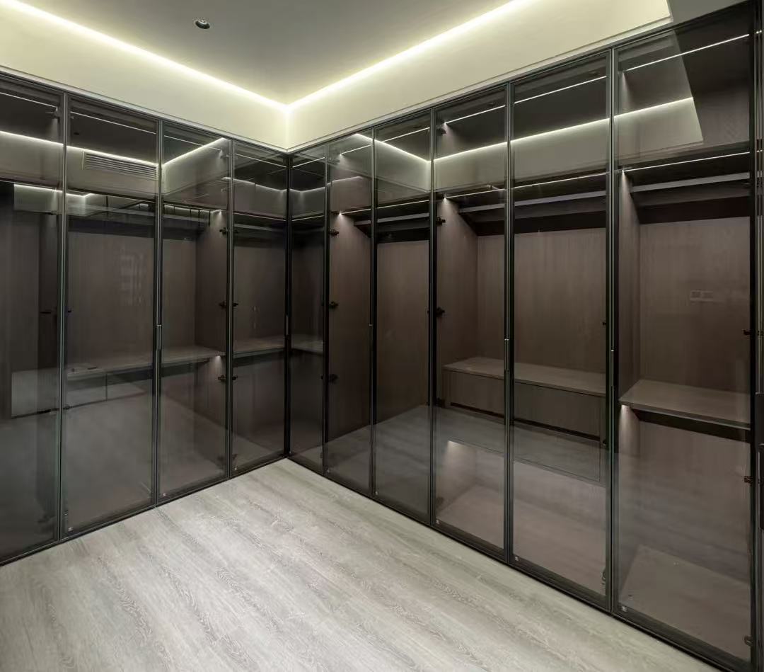 Modern walk-in closet with dark wood shelving and glass doors. Modern walk-in closet with dark wood shelving and glass doors.
