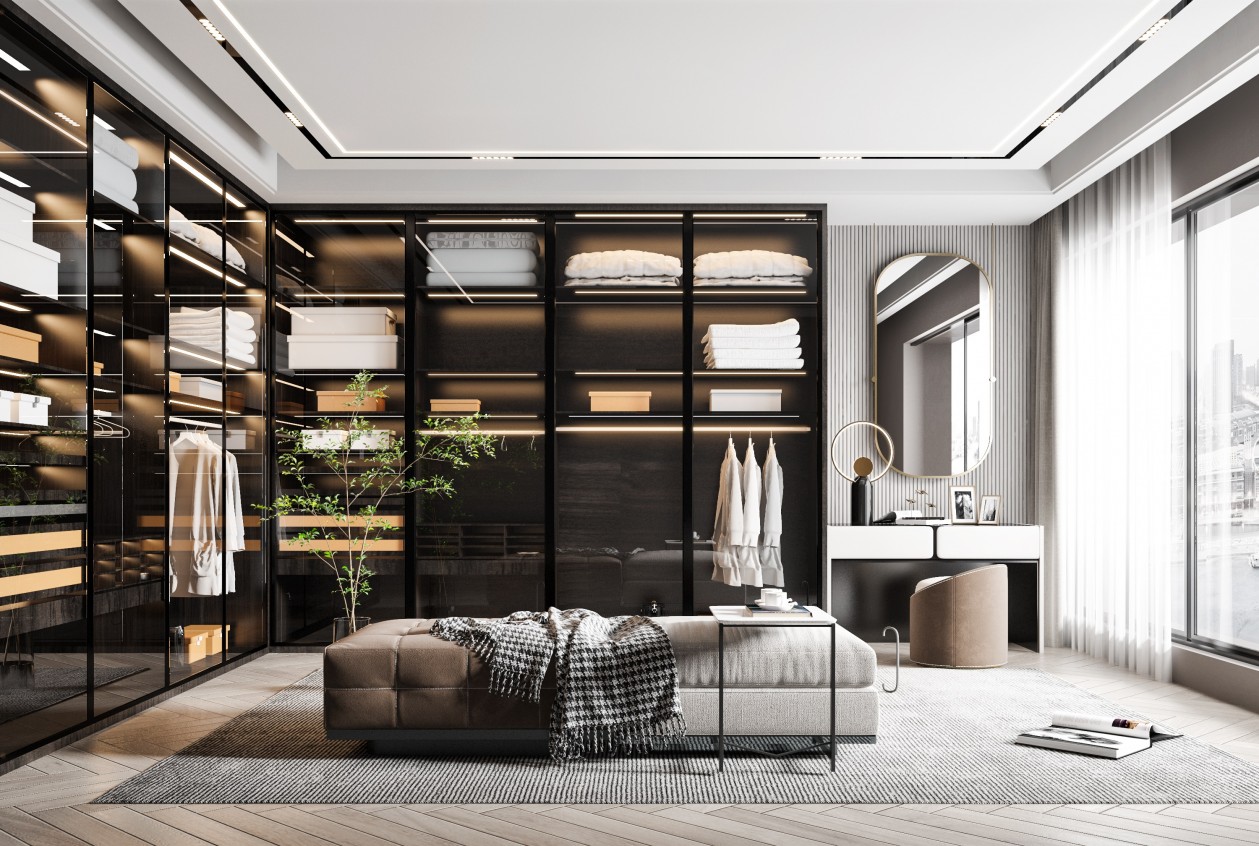 Modern walk-in closet with black-framed glass cabinets, central ottoman, and vanity area.