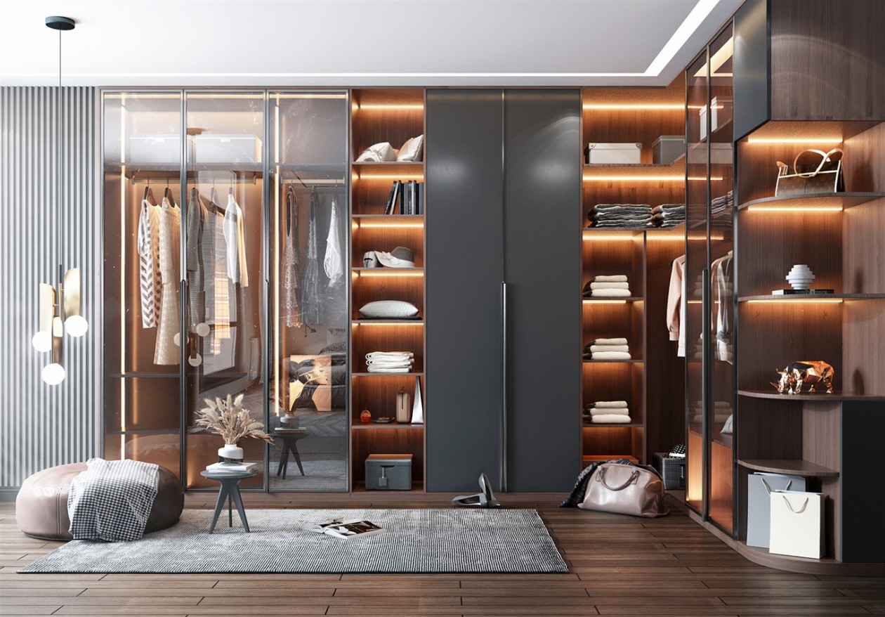 Luxurious walk-in closet with illuminated shelves and glass doors.