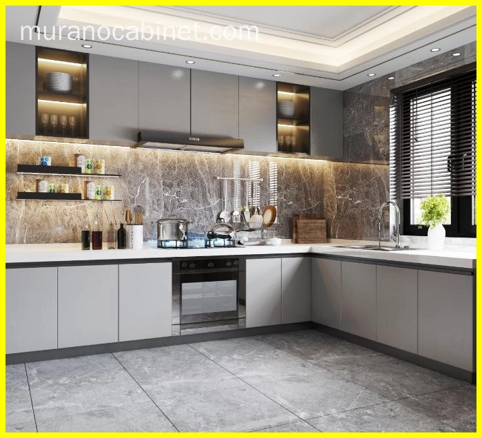 Modern kitchen with gray cabinets, marble backsplash, and stainless steel appliances.